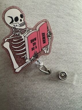 Skeleton Reading 'How to Be a Nurse' Glitter Badge Reel - Pink